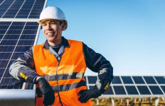 technician in front of solar panels