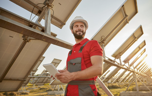Engineer working in field with solar batteries