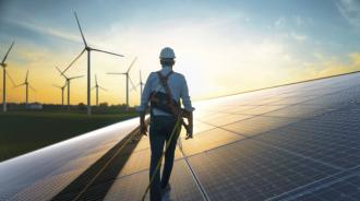 Technician Walking On Solar Panel Roof