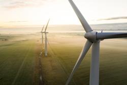 three wind turbines at sunrise