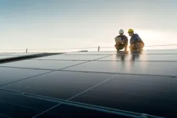 Two technicians on a solar roof panel 