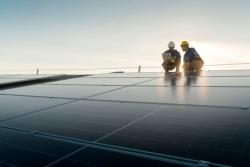 Two technicians on a solar roof panel 
