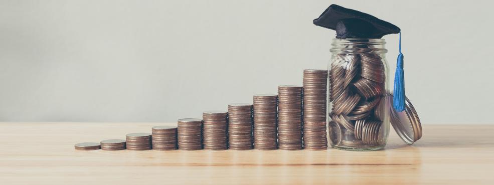 Stacked coins with Grad cap resting on top