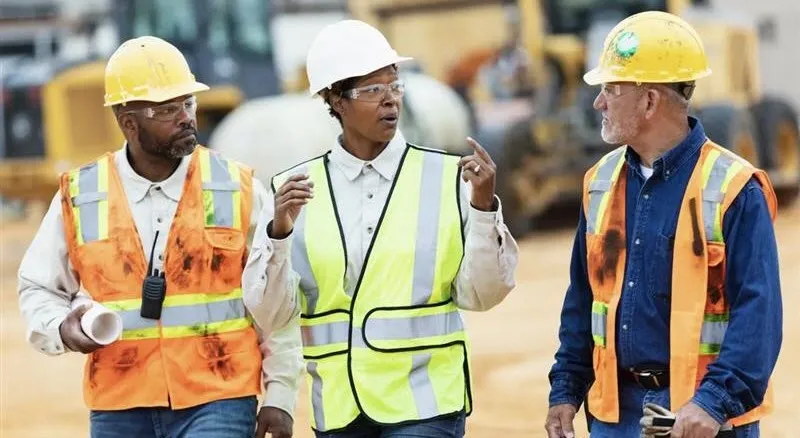 workers at construction site in safety gear
